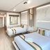 Ruean Phae Royal Park Hotel in Phitsanulok, twin beds in a modern guest room with TV and desk