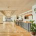 The Royal City Hotel Bangkok lobby with polished marble floors, reception desk, seating, and bright open space