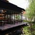 Spice House in Chiang Mai with an outdoor deck beside a reflective pond and lush greenery