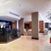 The Cura Hotel Kensington, London lobby with reception desk and modern lounge seating