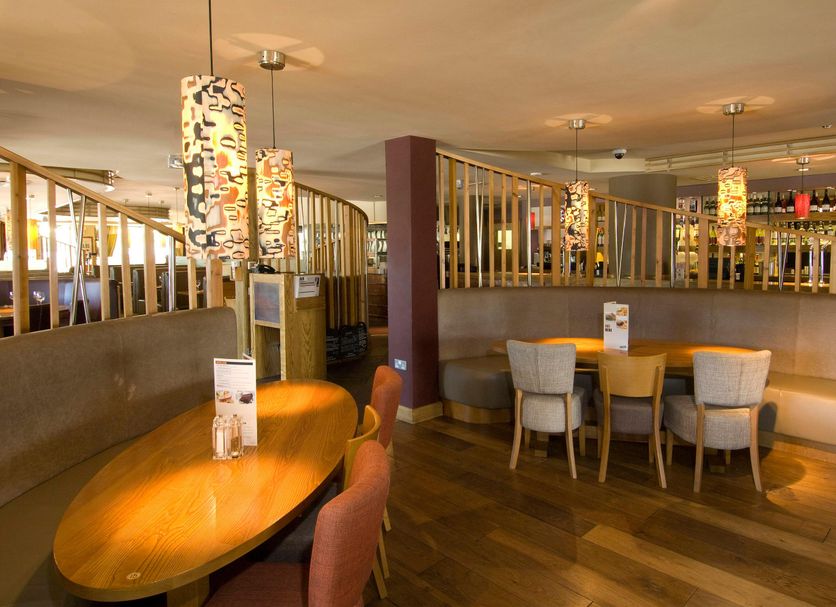 Premier Inn Ashford - Eureka Leisure Park dining area with curved booth seating and pendant lights