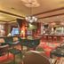Holiday Inn & Suites Madison West - Middleton by IHG lobby lounge with piano, bar, and colorful carpet