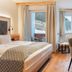 Wohlfühlhotel Berg Heil room in Holzgau with balcony mountain view, bed, desk and seating area