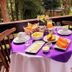 Breakfast table at Pousada O Cantinho da Raposa in Monte Verde on a wooded deck with garden view