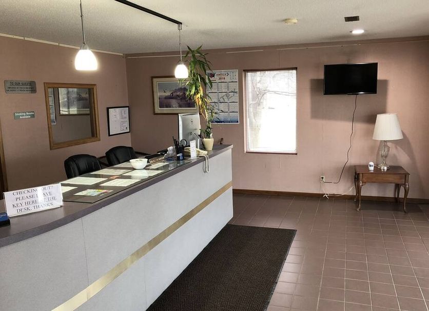 Denison Inn & Suites in Denison lobby with front desk, seating area, wall TV and window