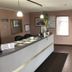 Denison Inn & Suites in Denison lobby with front desk, seating area, wall TV and window