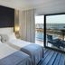 Real Marina Hotel & Spa in Olhão: twin beds beside a balcony with marina and water views