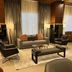 Best Western Plus Chihuahua Juventud lobby lounge with sofas, armchairs, coffee table and tall curtains