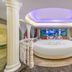Real Madrid Holiday Island Style Hotel, Haikou: circular bed in themed suite with mural and columns