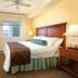 Worldmark Long Beach guest room with king bed, window, and lamps in Long Beach