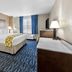 Baymont by Wyndham Port Arthur/Groves Area guest room with king bed, TV, desk and window seating