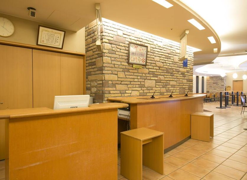 Washington R&B Hotel Kanazawa Eki Nishiguchi reception desk in Kanazawa with stone accent wall