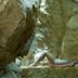 Park Hotel Tyrrenian in Amantea: guest relaxing on a stone ledge in a rocky cave spa area