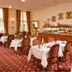 Hotel & Apartments Zarenhof Berlin Prenzlauer Berg dining room with set tables and bar in Berlin