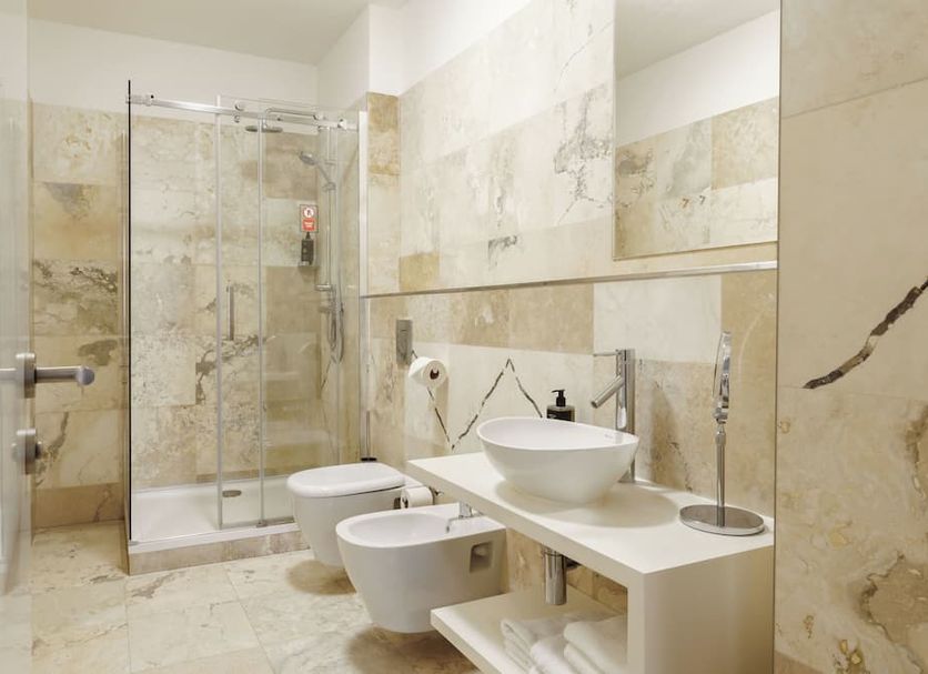limehome Prague Halkova bathroom with glass shower, bidet and vessel sink in Prague