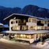 Hotel Jägerhof Mayrhofen in Mayrhofen, snow-covered chalet hotel at dusk with lit windows and mountain backdrop