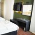 Hotel Guleryuz in Antalya room with twin beds, wall-mounted TV, and a vanity area