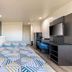 Studio 6 Suites Perris, CA guest room with two beds, desk, and TV
