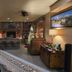 Buffalopeaks Lodge in Buena Vista with rustic lobby, stone fireplace, wood beams and seating area
