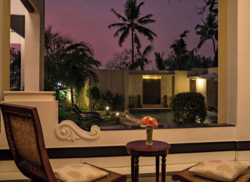 Amritara The Poovath Beachfront Heritage, Fort Kochi courtyard view at dusk with palms and pool