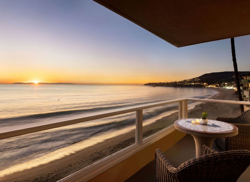 Pacific Edge Hotel in Laguna Beach balcony with ocean sunset view and beach shoreline