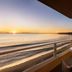 Pacific Edge Hotel in Laguna Beach balcony with ocean sunset view and beach shoreline