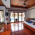 Blue Diamond Resort, Ko Tao room with pool view through sliding glass doors and wooden ceiling