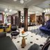 The Adelphi Hotel in Saratoga Springs lobby with ornate seating, chandeliers and patterned carpet