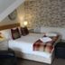 The Darnley Hotel Ilfracombe bedroom with double bed, bedside lamps and plaid accents
