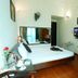 A25 Hotel Mai Hac De in Hanoi guest room with bed, desk, wall TV and mirror