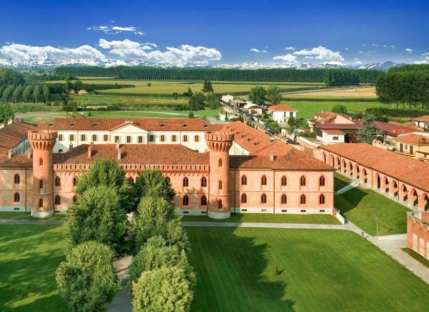 Albergo dell'Agenzia in Bra, historic hotel with red-tiled roofs, towers, and landscaped grounds