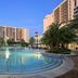 Hilton Grand Vacations Club Parc Soleil Orlando pool at dusk with palm trees and resort towers