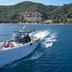 Nido, Mar-Bella Collection an SLH hotel in Agios Ioannis Peristeron, yacht on blue sea by green hills
