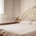 Agriturismo Cerrolungo in La Spezia guest room with ornate wrought-iron headboard and double bed