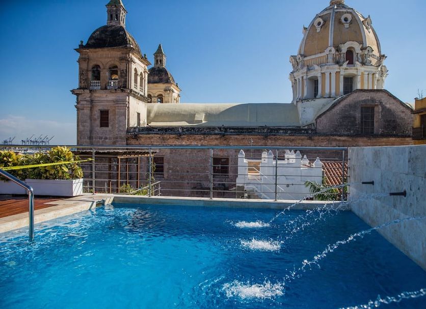 Casa Claver Loft Boutique Hotel rooftop pool with Cartagena cathedral domes in the background