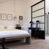 Les Jardins De La Livrée in Villeneuve-lès-Avignon bedroom with bed, framed art and bedside lamps