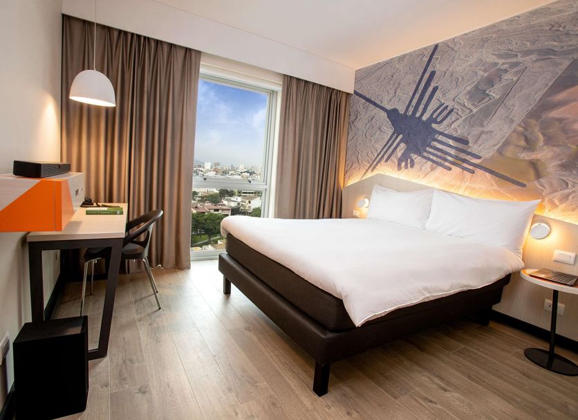 ibis Styles Lima Benavides Miraflores room with king bed, desk and city view in Lima