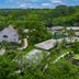 Hotel Villa Mercedes Palenque aerial view of tropical grounds, thatched-roof villas and a pool