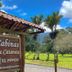 Cabinas La Catarata in La Fortuna entrance sign with tropical garden and mountain view