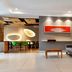 Brizo Salta lobby with gray sofa, wood stairs, and modern dining area in Salta