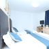 Yuexin Hotel Guangzhou room with twin beds, desk, chair, and window with dark curtains
