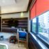 Hotel Golden Treat, Indore guest room with bed, desk, TV, window and city view