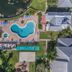 Barefoot Suites in Kissimmee with aerial view of two outdoor pools beside a lake