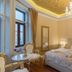 Central Square Heritage Hotel Split room with chandelier, ornate ceiling, king bed, and city-view window