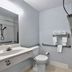 Studio 6 Ft Worth - North Richland Hills bathroom with shower, sink, toilet and towel rack