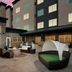 Residence Inn by Marriott New Orleans Elmwood courtyard with fire pit, lounge seating, dining table and cabana daybed