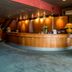 Arass Hotel & Business Flats Antwerp lobby with curved wood reception desk and lounge seating
