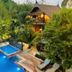 Boutique Village Hotel in Krabi with outdoor pool, lounge chairs, and tropical garden views