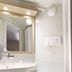 Première Classe Châlons-en-Champagne bathroom with sink, mirror, towel, and toilet in Saint-Martin-sur-le-Pré