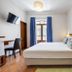 Residencial Mares, Tavira guest room with double bed, desk, TV and balcony doors
